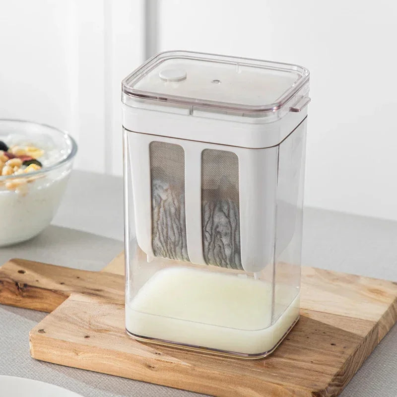 Greek yogurt strainer with thick strained yogurt in the mesh basket