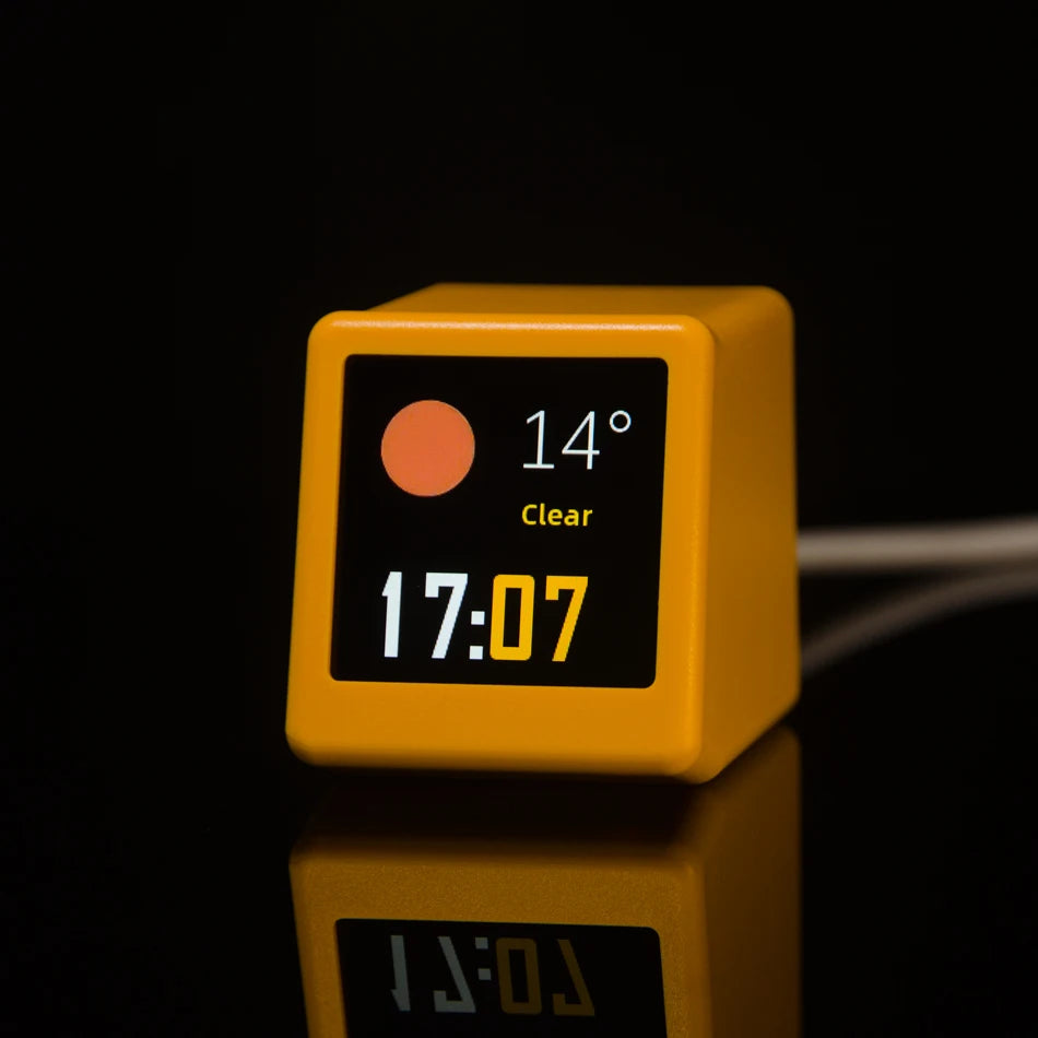Smart desk clock on a desk beside a keyboard