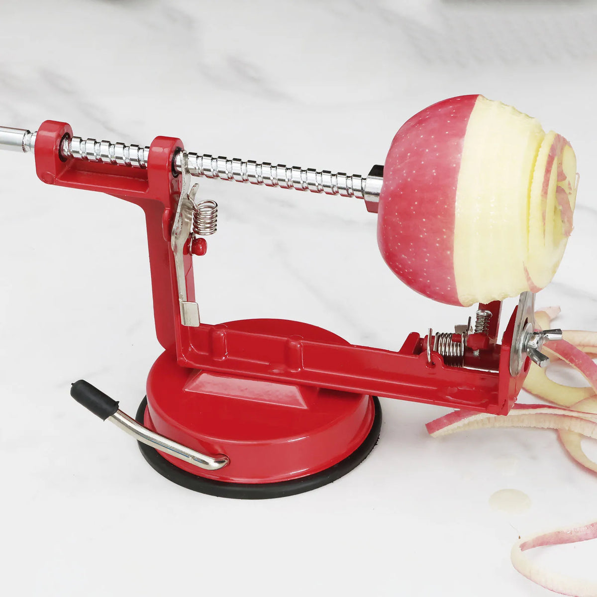 Apple peeler coring and spiral-slicing an apple