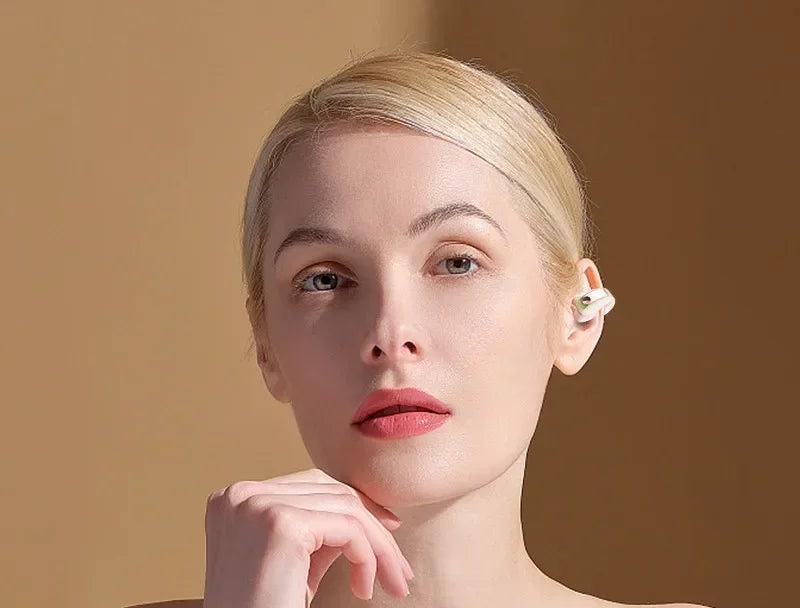 Woman wearing the open-ear clip earbud
